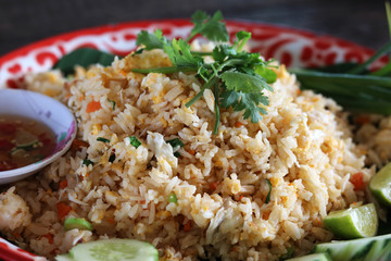 Close up of crab meat fried rice on Thai  traditional plate with vegetable and fish sauce. Popular Thai food.