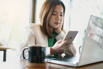 business woman working with use computer and smartphone in coffee shop. business relaxing and break time. freelance working and freedom work. business finance success.