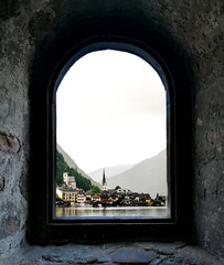 the magic view of hallstatt from an old stone window