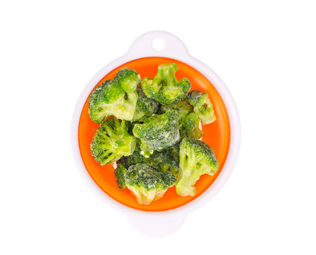 Frozen broccoli florets in bowl.