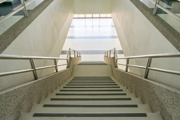 looking down staircase in light villa interior