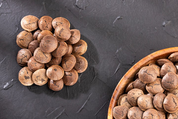 Plukenetia volubilis - Dried seeds of sacha fruit. Inchi peanuts. White background