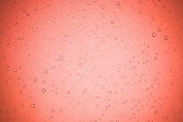 Rain droplets on red glass background, Water drops on glass.
