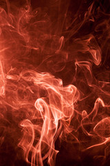 Red smoke on a black background.