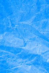 Blue vignette crumpled paper.