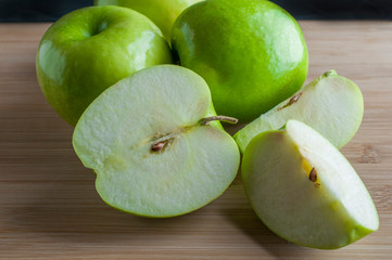 Green apples on a wooden cutting board