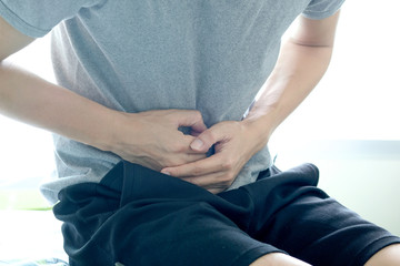 People have abdominal pain. Take a hand from the belly diarrhea.Health concept