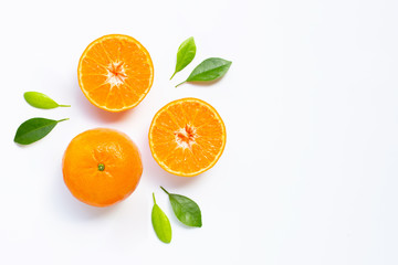 Fresh orange citrus fruit with leaves on white background.