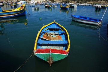 Fototapeta na wymiar close up colorful traditional wooden fishing boats in harbor of Mediterranean island Malta