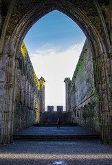 young traveler acknowledges the grand architecture of a goth style castle 