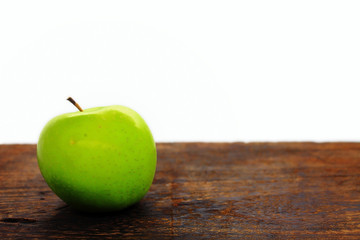 green apple on wooden table