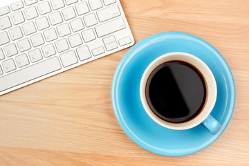 Black coffee in blue cup on brown wooden table background