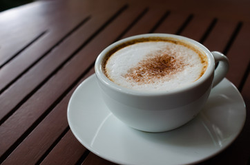 cup of coffee on wood table.