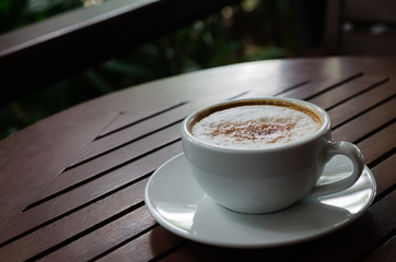 cup of coffee on wood table.