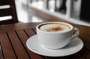 cup of coffee on wood table.