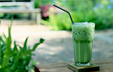 Iced green tea in crystal glass with stainless steel straw for drink.  Concept for reduce plastic pollution and support green eco friendly products.