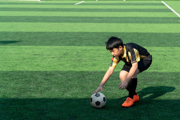 Asian Boy Training Football on the Pitch. Soccer Football Training Session for Kid