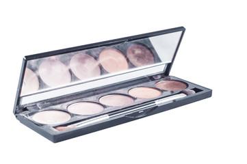Palette with different shades of face shadows and brush applicator for application. Makeup set with a mirror on a white background, isolate.