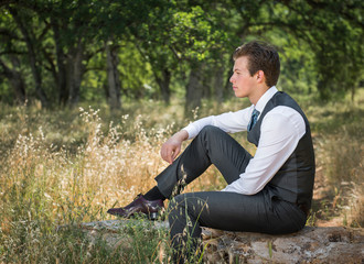 Naklejka na ściany i meble Outdoor portrait of a young man in a business suit