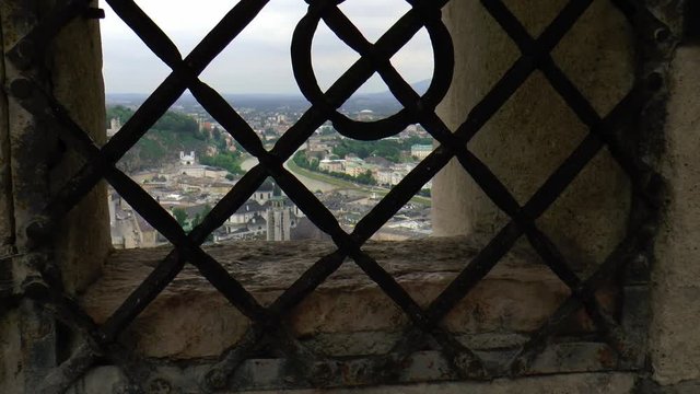 Salzburg viewed through the bars of fortress Hohensalzburg.