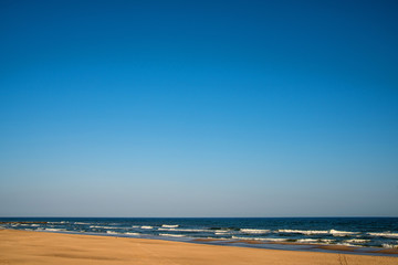 lonesome beach of the Baltic Sea in Poland with blue sky