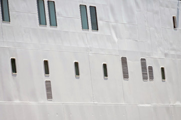 Portholes in the white hull of ship