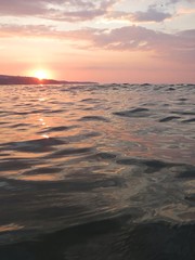 Fototapeta na wymiar Sunset over the sea waves
