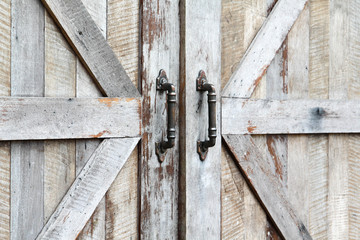 Antique style door handle on wooden door.