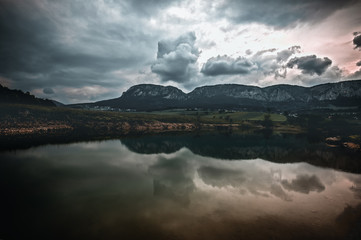 Mountains reflected on the lake. cloudy sky in lower Austria