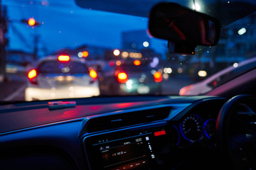 Fototapeta na wymiar Defocused Image Of Traffic On City Street At Night, view from inside car. 