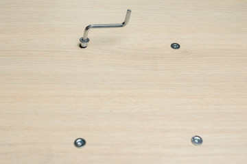 Furniture assembly using a tools, cordless screwdriver, clips and clamps close up.  Assembling Flat Pack Furniture