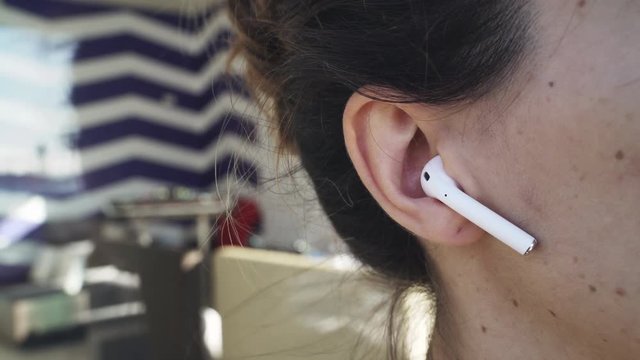 Woman with wireless earphones