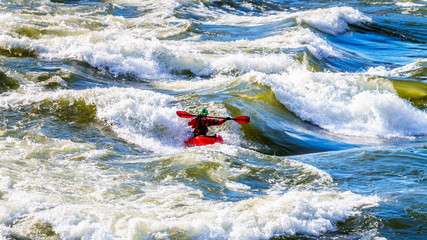 Kayaker navigating through the White Waters of the Thompson River as the river winds  through the...