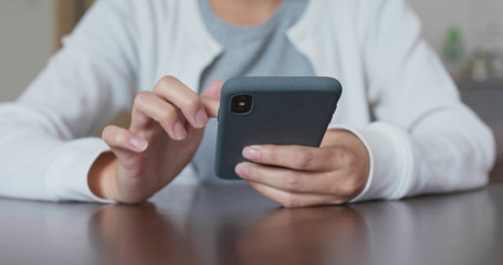 Woman use of mobile phone at home