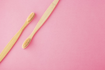 Bamboo toothbrushes on pink background