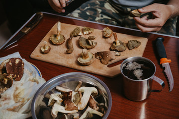 Table mushroom picker. Sliced ​​mushrooms and knife are on  table