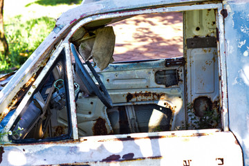Interior of old car with the steering wheel and dashboard,Steering wheel inside an old rusted truck on the side of a highway.