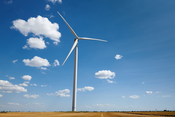wind generator on bright cloudy sky background