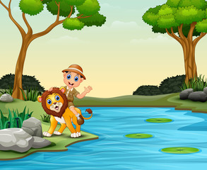 Obraz na płótnie Canvas Happy zookeeper boy and lion near a river