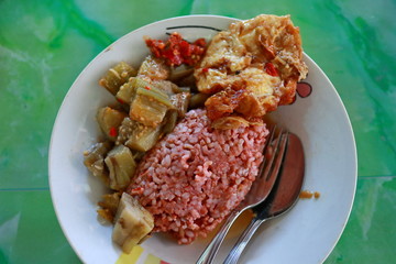 traditional Javanese food containing red rice with eggplant and egg dishes