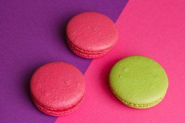 Red green cookies on a pink and purple background.
