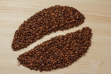 coffee bean logo made from coffee beans on a wooden background