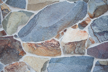 Artificial stone laying for facing texture for a background of gray, brown and orange color
