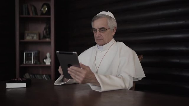 Pope uses internet on tablet pc in his office in Vatican