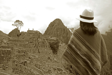Sepia Image of a Female in Poncho Looking at the Amazing Inca Ruins of Machu Picchu, Cusco Region,...
