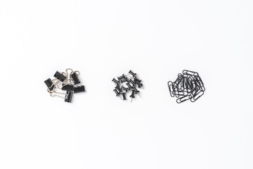 Various kinds of  black paperclips and drawing pins