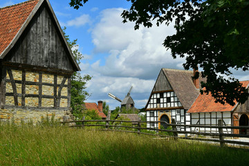 Obraz premium Rustic summer landscape. Beautiful village photo, old houses, green grass, blue sky.