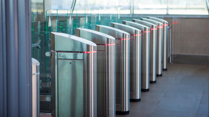No passage, concept. Turnstiles are closed, chrome turnstiles with a red