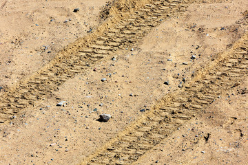 Traces of tire treads on the sand.