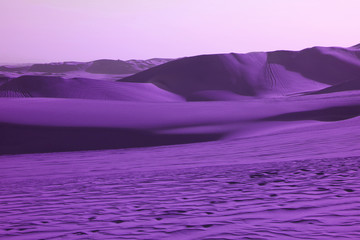 Surreal pop art styled vibrant purple colored desert with fantastic sand ripples and sand dunes
